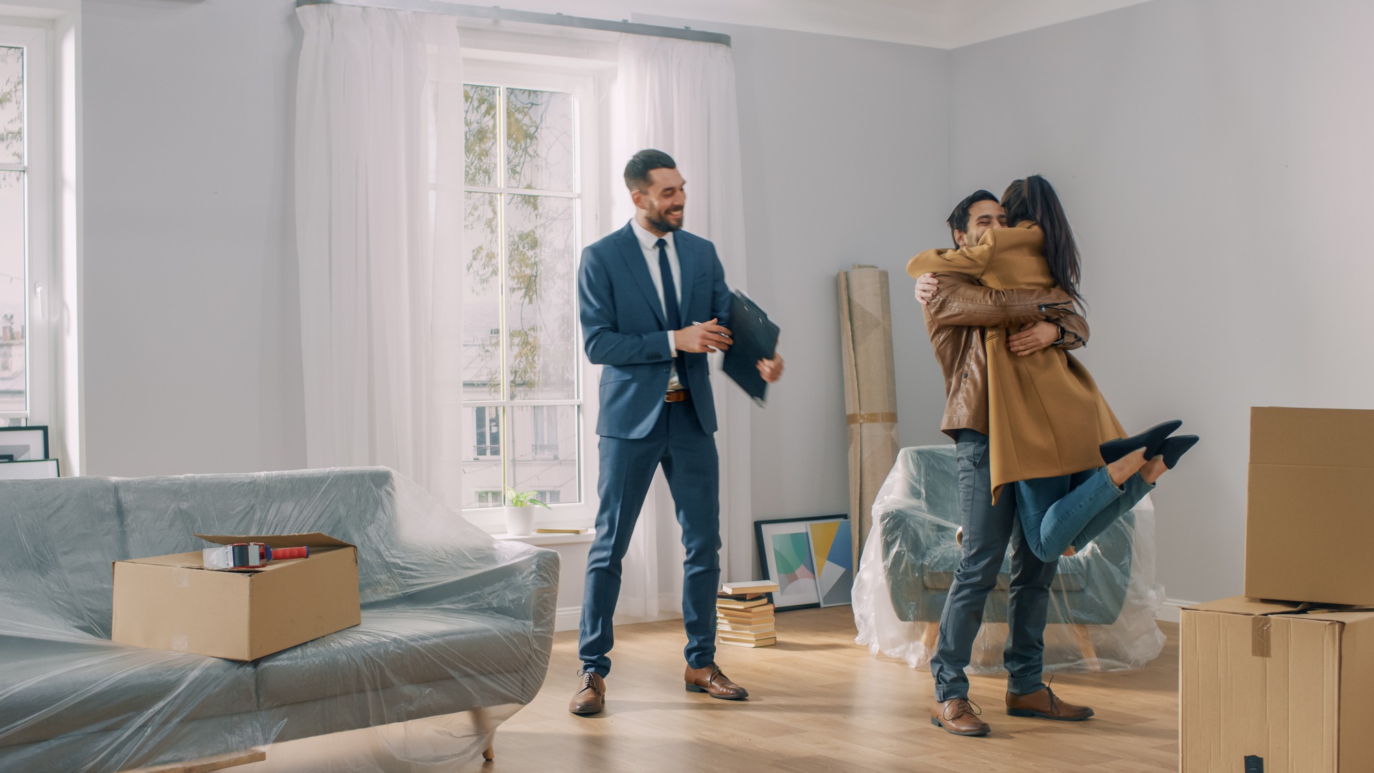 Real Estate Agent Shows Bright New Apartment to a Young Couple.